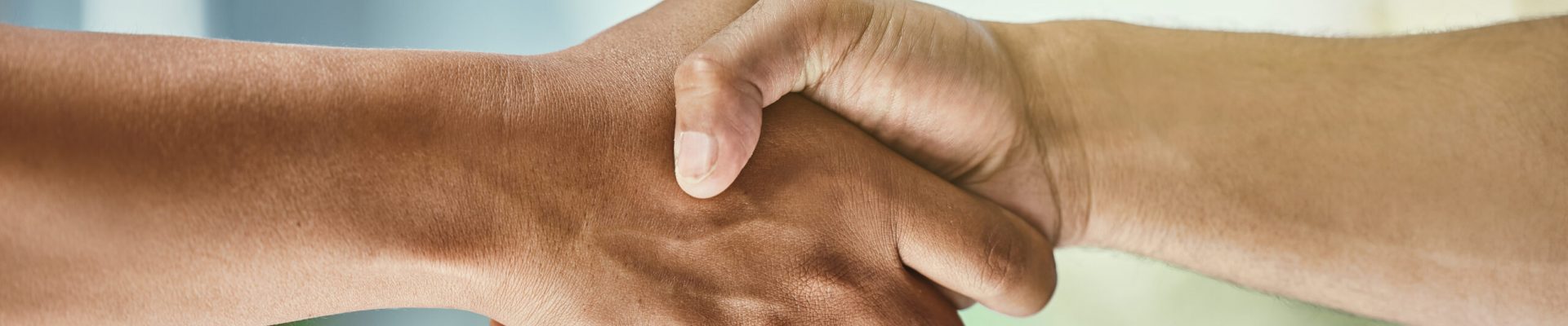 Business people, handshake and partnership with team in greeting, agreement or deal at office. Closeup of employees shaking hands for introduction, b2b or welcome in hiring, collabration or workplace.